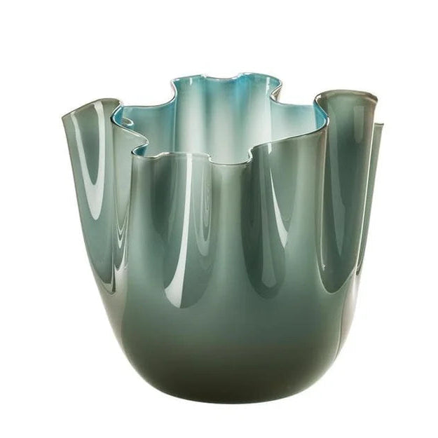 Green glass vase with wavy design on a white background